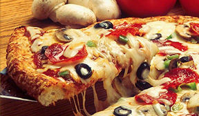 Fresh pizza slice being cut away from the rest of the pizza.