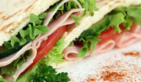 Lettuce, turkey, tomato wrap close up view.